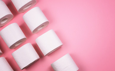 A few rolls of toilet paper on a bright colored background.