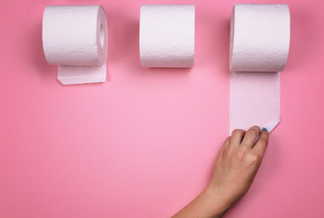 A few rolls of toilet paper on a bright colored background.