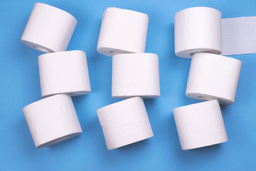 A few rolls of toilet paper on a bright colored background.