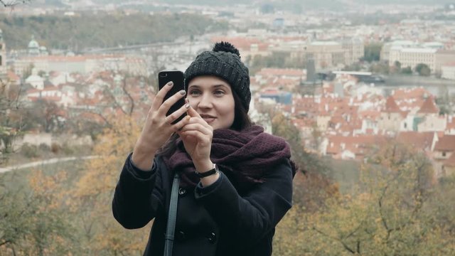 Beautiful Young Woman Tourist In Prague, Making Selfie or Taking Photo With Her Mobile Phone, Travelling Concept