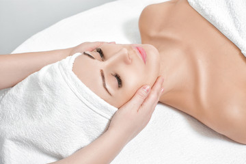 Fototapeta na wymiar woman receiving facial massage at spa salon