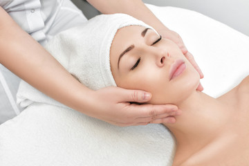 Obraz na płótnie Canvas woman receiving facial massage at spa salon