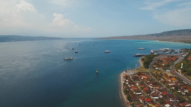 Aerial view ferry port Gilimanuk with ferry boats, vehicles and infrastructure, Bali,Indonesia. Ferries for transport vehicles and passengers in the port. Port for departure from Bali to the island of