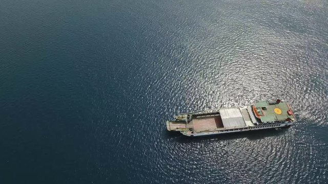 Aerial view passenger ferryboat in the blue sea, Gilimanuk, Bali,Indonesia. Ferry in the ocean. Port for departure from Bali to the island of Java. 4K video. Travel concept. Aerial footage.