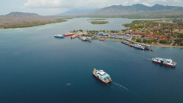 Aerial view ferry port Gilimanuk with ferry boats, vehicles and infrastructure, Bali,Indonesia. Ferries for transport vehicles and passengers in the port. Port for departure from Bali to the island of