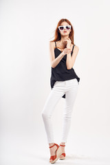 Young beautiful woman in sunglasses on white isolated background