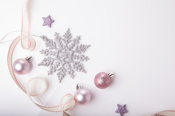 Christmas holiday composition. Festive creative gold silver pattern, xmas pink decor holiday ball with ribbon, snowflakes on white background. Flat lay, top view