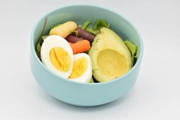 Green Salad in a Blue Bowl on White Backgroun