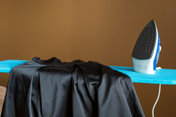 Ironing of delicate fabrics with iron. Dress for a holiday