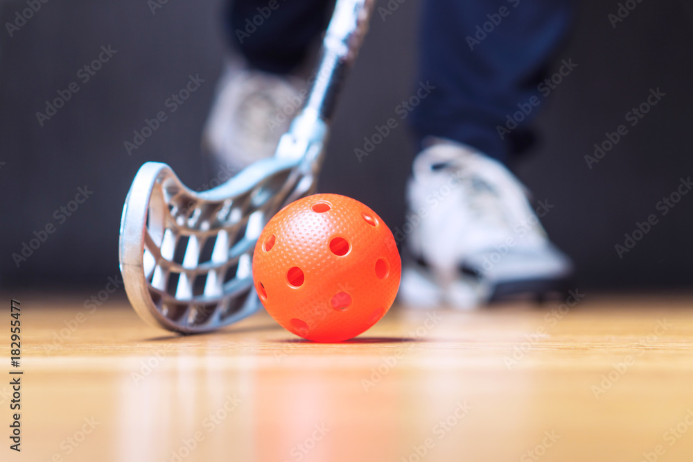 Wall mural floorball player with stick and ball. floor hockey concept.