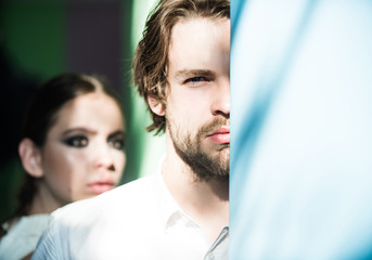 Fototapeta premium Man hide half face with beard and blurred woman