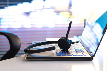 Help desk, 24/7 customer service, support hotline or call center concept. Headset on laptop...