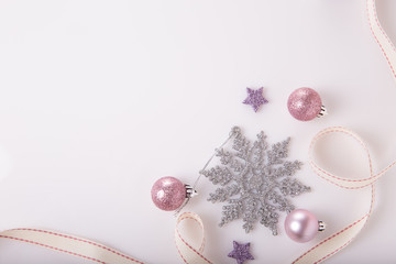 Christmas holiday composition. Festive creative gold silver pattern, xmas pink decor holiday ball with ribbon, snowflakes on white background. Flat lay, top view