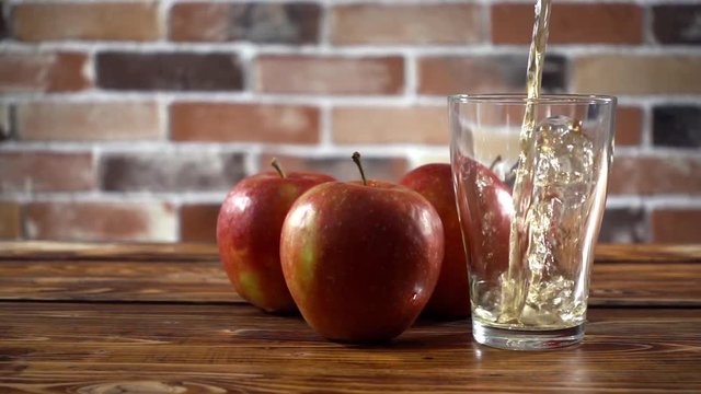 Pouring apple cider in glass on the kitchen