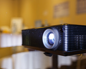 black projector on the table prepared to broadcast video and presentation.