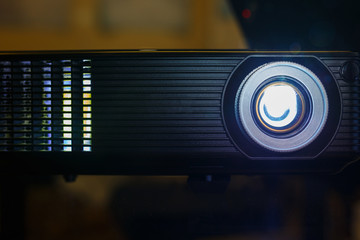 black projector on the table prepared to broadcast video and presentation.