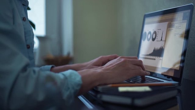 Young man using laptop at home. Freelancer working at home.