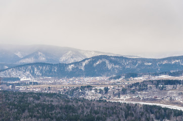 Autumn and winter landscape, the mountain and the river freezes