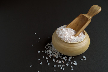 Pink salt in wooden bowl.