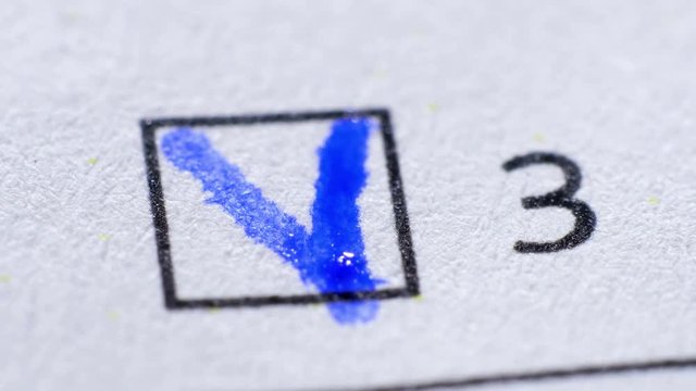 Tick in ballot box, voting and elections. Extreme close up.
