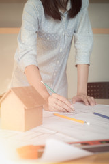 Alone architect woman working with compasses and blueprints for architectural plan,engineer sketching a construction project concept.Architect concept,Vintage Effect