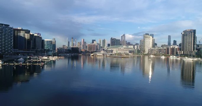 Melbourne Docklands area on Yarra river surrounded by high-rise towers as part of modern city waterfront.
