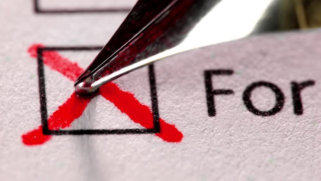 Cross in tick box, voting and elections. Extreme close up.
