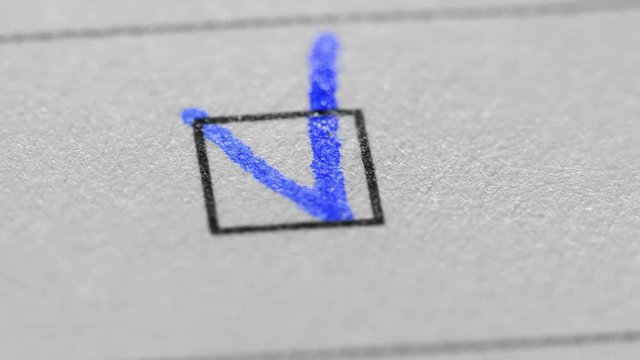 Tick in ballot box, voting and elections. Extreme close up.
