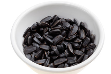 Sunflower seeds/ Sunflower seeds in a bowl on a white background