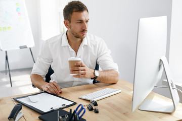 Young Business Man Working On Computer In Office.