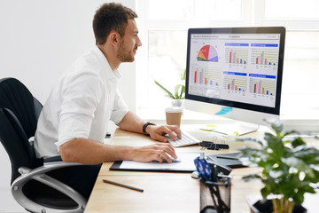 Young Business Man Working On Computer In Office.