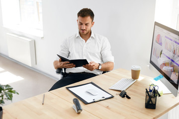 Young Business Man Working On Computer In Office.