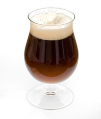 Black beer in chalice glass isolated on white background