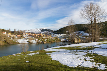 Town farm with snow in winter: Alba de los Carda&ntilde;os beside the reservoir of Camporredondo in Palencia Spain