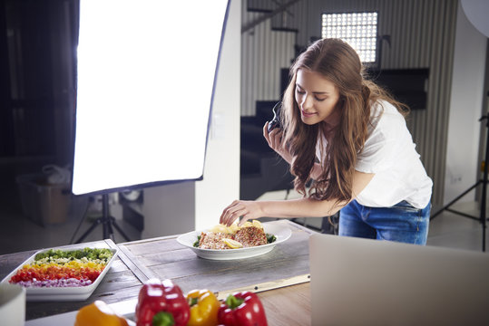Blogger arranging food for a photo