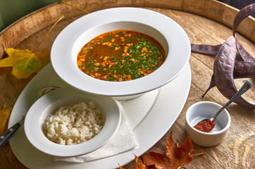 Traditional Georgian soup Kharcho with meat and rice on wooden background