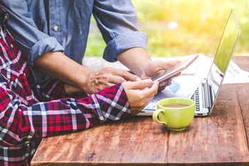 Business team analyzes charts and graphs revenue with cutting-edge laptop computers on the table.
