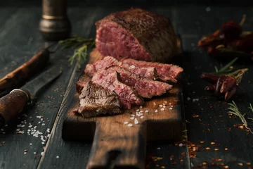 Foto auf Acrylglas Steakhouse Gegrilltes Steak mit Gewürzen und Kräutern