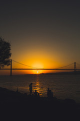 People enjoying the sunset by the river Tejo