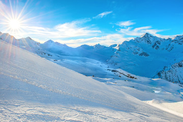 Fototapeta na wymiar Mountains with snow peaks and sunset sky