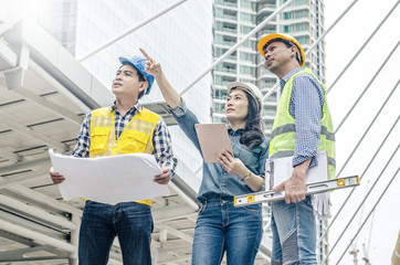 View of Three workers checking last details on a construction site