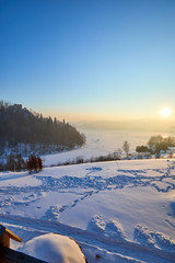 Obraz premium Snow covered trees in the mountains at sunset. Beautiful winter landscape. Winter forest.