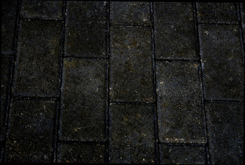 Scratched grey square road tiles texture