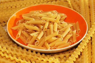 Pasta on the orange dish, an Italian dish. Dry the product.