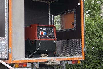 Industrial Diesel Generator. Standby generator. Industrial Diesel Generator for Office Building connected to the Control Panel with Cable Wire. Backup Generator Power.