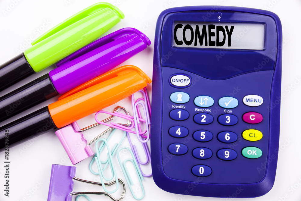 Poster writing word comedy text in the office with surroundings such as marker, pen writing on calculator. 