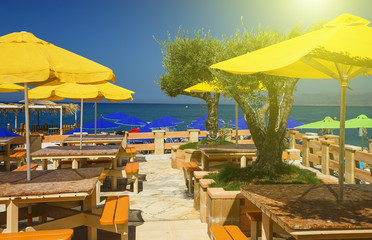 empty cafe on the seashore close to water in summer, Greece, Crete island
