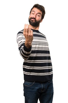 Man with beard doing coming gesture