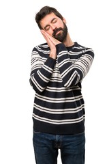 Man with beard making sleep gesture