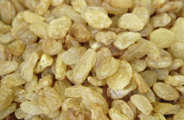 Yellow raisins white background.